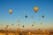 Hot air balloons festival in Cappadocia. Many colorful balloons against vibrant sky. Travel and tourism concept