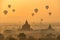 Hot air balloons float over pagodas field