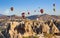 Hot air balloons fly in clear morning sky near Goreme, Kapadokya, Turkey