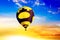 Hot air balloons fly in sunset sky against background