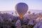 Hot air balloons flying in beautiful Cappadocia hilly landscape, amazing tourism attraction in Goreme, Anatolia, Turkey, morning