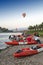 Hot air balloons flying over Nam Song River and tourist kayaks in Vang Vieng, popular resort town in Lao PDR