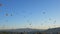 Hot air balloons flying over valleys in Goreme, Cappadocia, Turkey.