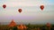 Hot air balloons flying at sunrise over ancient Buddhist Temples at Bagan. Myanmar