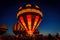 hot air balloons glowing in night sky