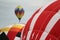 Hot air balloons inflate during a mass ascension