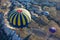 Hot air balloons landing during sunrise after Flying over colourful rock formations in Cappadocia, Turkey in Goreme.