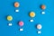 Hot air balloons made of macarons isolated on blue, abstract concept.