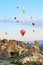 Hot air balloons over mountain landscape in Cappadocia