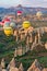 Hot air balloons over mountain landscape in Cappadocia