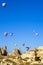 Hot air balloons overhanging the ancient dwellings of the bewitching Cappadocia, Turkey