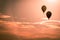Hot air balloons soaring through the air at sunset at an air show