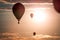 Hot air balloons soaring through the air at sunset at an airshow