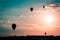 Hot air balloons soaring through the air at sunset in Michigan