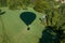 Hot-air balloonÅ› shadow on green field with hide