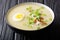 Hot Arroz Caldo traditional rice soup with chicken, vegetables a