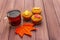 Hot autumn drink. Black tea with cupcakes, colorful leaves