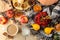 Hot autumn drink, coffee or cocoa, with yellow leaves and decorative pumpkins, acorns and apples on a natural wooden table. autumn