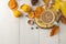 Hot autumn drink, coffee or cocoa, with yellow leaves and decorative pumpkins on a white wooden table. autumn composition. top vie