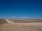 Hot beautiful day on adventure road trip through desert rock mountain landscape route to emptiness with blue sky background