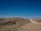 Hot beautiful day on adventure road trip through desert rock mountain landscape route to emptiness with blue sky copyspace