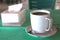 Hot black coffee cllose up photo with teaspoon and tissue pack