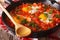 Hot breakfast shakshuka in a pan close-up. horizontal