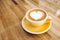 Hot cappuccino coffee cup on wooden tray with heart latte art on wood table at cafe,Banner size food and drink concept