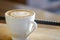 Hot Cappuccino with white cup on wood table