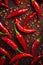 Hot chili peppers depicted in contrast against a dark background. The juicy, red peppers create a visual effect.