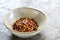 Hot Chilli Flakes in Stoneware Bowl over Slate Background