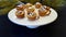 Hot chocolate cookie cups on white pedestal plate