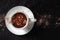 Hot chocolate in a cup with cocoa powder, shot from above with a place for text
