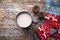 Hot chocolate in a grey cup and red christmas ornament socks with deer. Top view