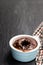 Hot chocolate lava cake in clay pot on black stone background