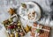 Hot chocolate with marshmallows, christmas decorations, fluffy carpet on a gray background, top view. Christmas background