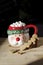 Hot chocolate Santa Clause cute mug with marshmallows, and gingerbread cookies on wooden table
