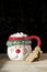 Hot chocolate Santa Clause cute mug with marshmallows, and gingerbread on wooden table with copy pace