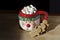 Hot chocolate Santa Clause cute mug with marshmallows, and gingerbread on wooden table with copy space