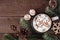 Hot chocolate with snowman marshmallows, above view table scene with Christmas corner border over wood