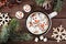 Hot chocolate with snowman marshmallows, top view table scene with Christmas decor over wood