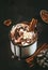 Hot chocolate with whipped cream and cocoa powder in metal mugs. Winter and autumn time. Christmas warm drink. Copy space