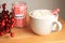 Hot coco with peppermint sticks jar with a cranberry wreath