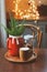 Hot cocoa with marshmallow, fir branches and Christmas decorations on wooden table in country house