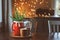 Hot cocoa with marshmallow, fir branches and Christmas decorations on wooden table in country house