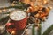 Hot cocoa with marshmallows and croissant on rustic wooden table with christmas lights