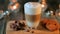 hot coffe latte cappucino with oatmeal cookies and chocolate pieces in a transparent glass. The