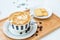 Hot coffee on background served with cream crackers on white plate