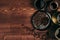 Hot coffee in black cup and turkish pots cezve with beans, saucer with copy space on brown old wooden board background, top view.