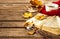 Hot coffee, book, glasses and autumn leaves on wood background